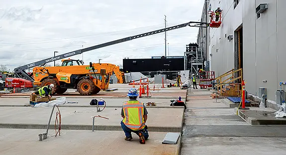 construction site for data center with cherry picker and forklifts